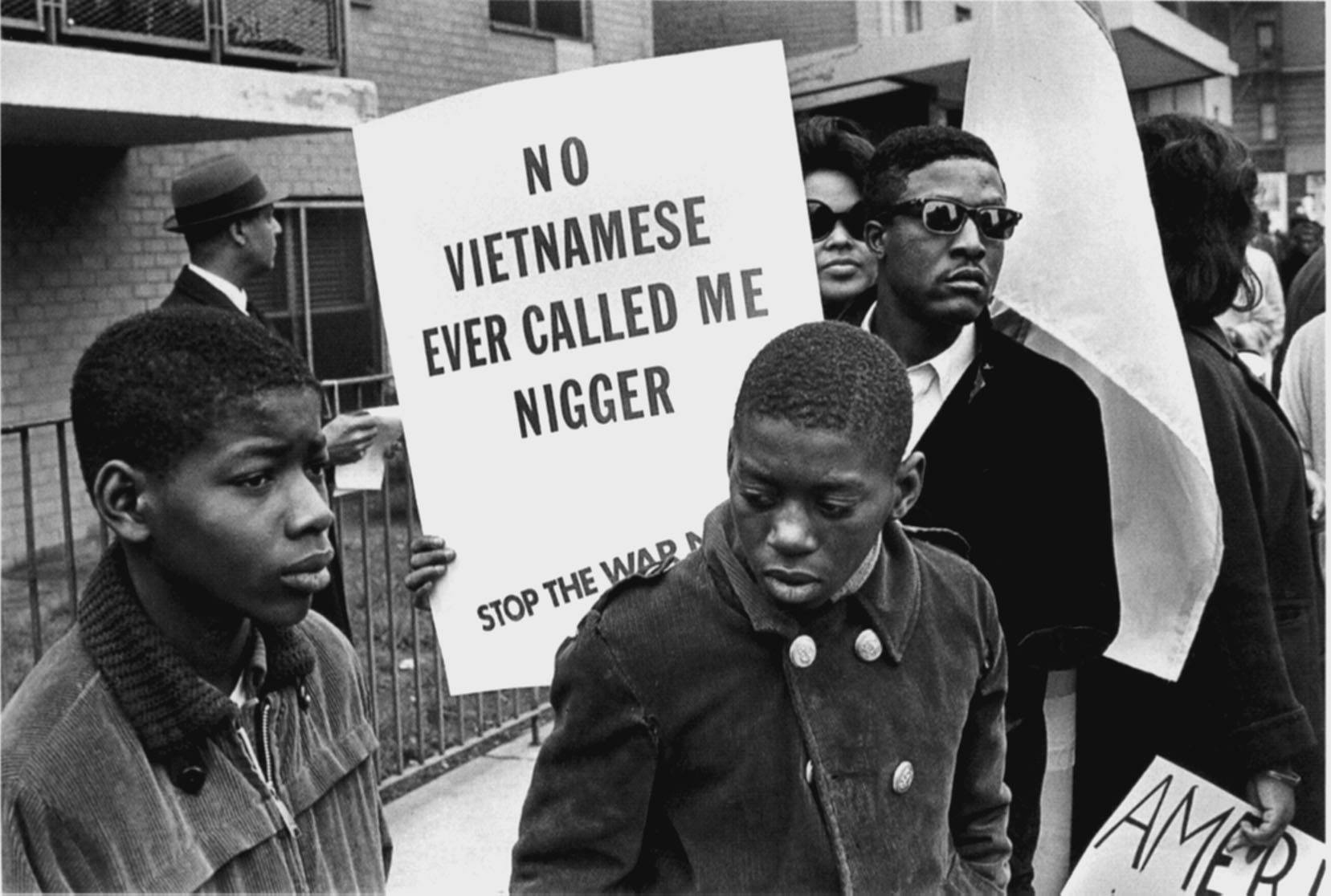 Demonstrator at the Harlem Peace March to end racial oppression carries an anti-war sign, 1967