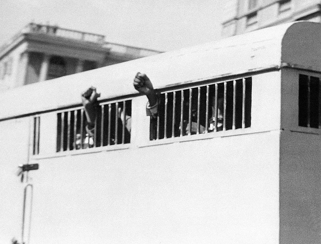 Nelson Mandela keeps his fists raised after he was sentenced to life imprisonment, June 1964